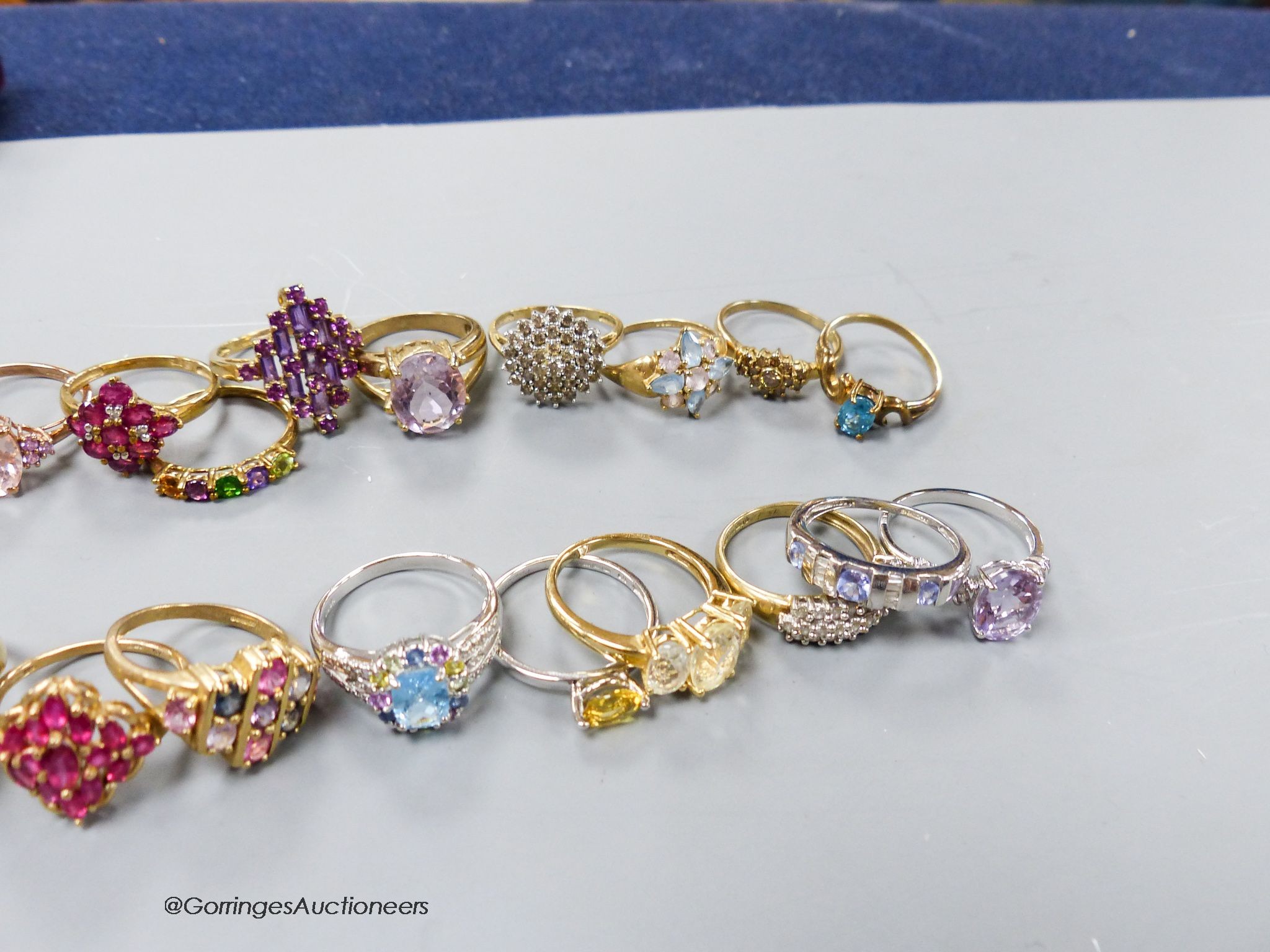 Twenty assorted modern 9ct or 9k and gem set dress rings, gross 59.1 grams.